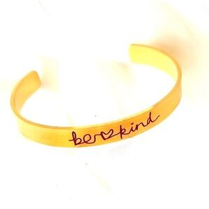 gold-tone cuff bracelet features,inspirational message "be kind"